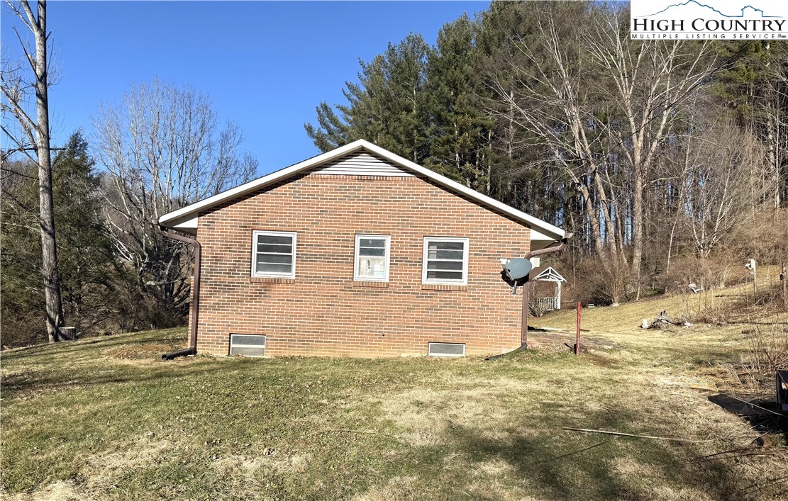 288 Sussex Road Grassy Creek, NC 28631 - Photo 2 of 22 a view of a house with a yard