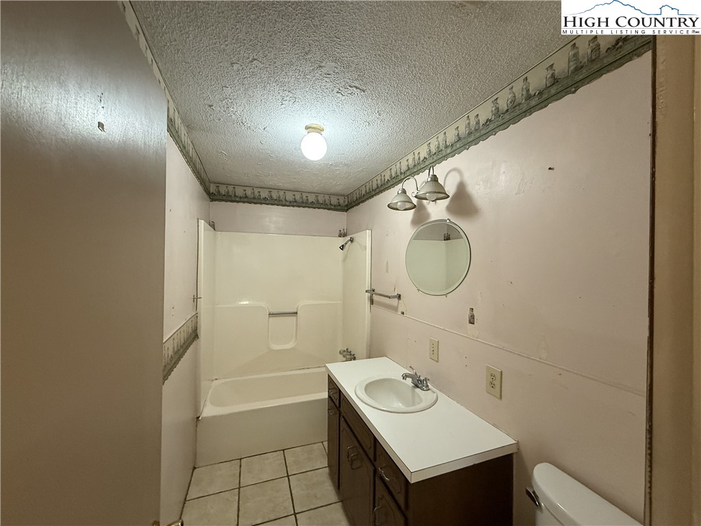 288 Sussex Road Grassy Creek, NC 28631 - Photo 10 of 22 a bathroom with a sink mirror toilet and bathtub