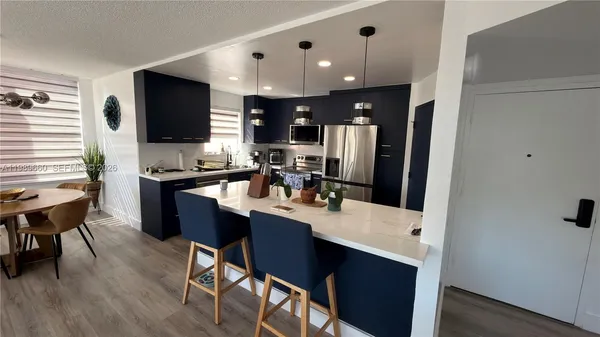 a kitchen with a dining table and chairs