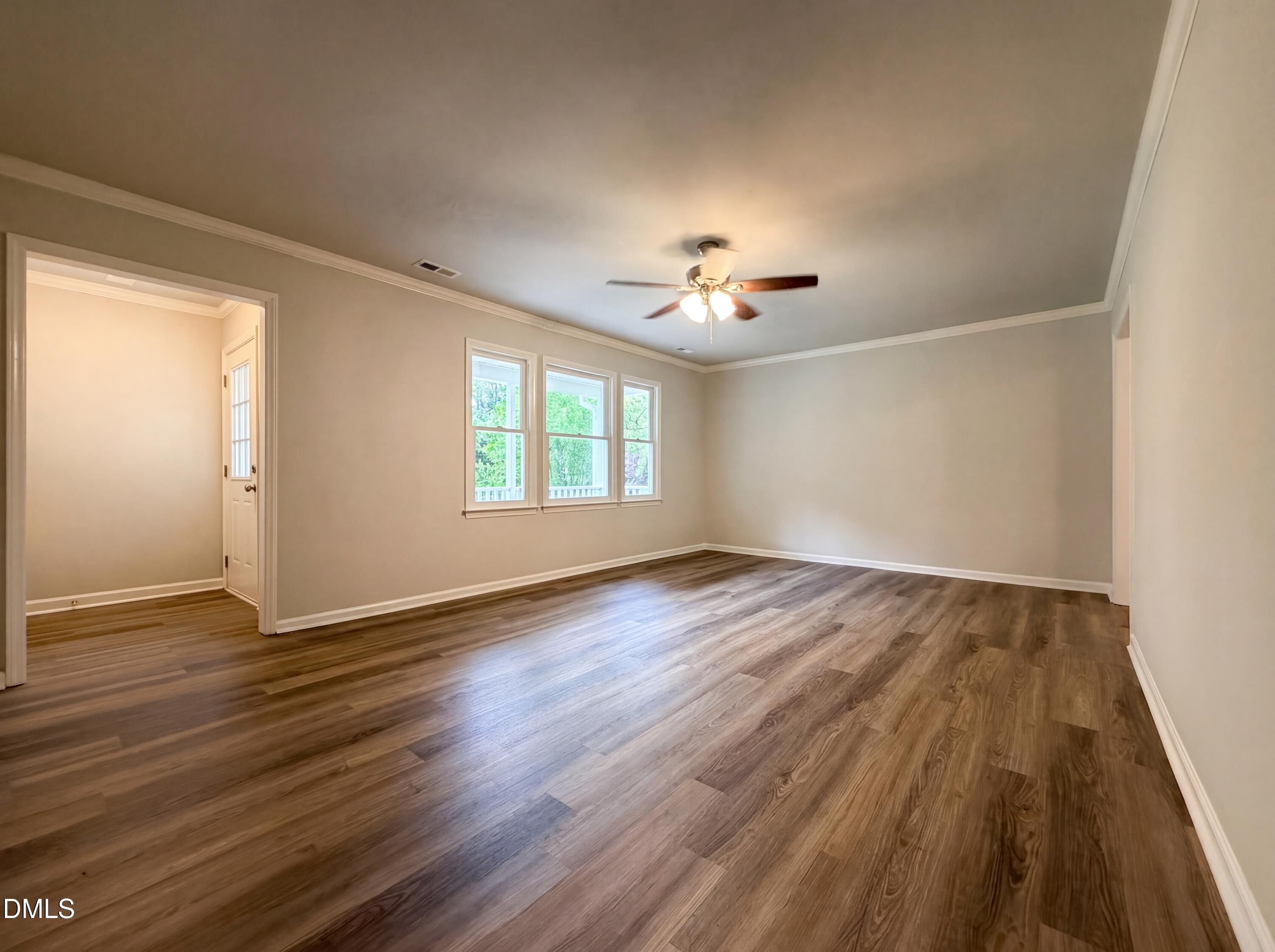 4894 Elevation Road, Unit C Benson, NC 27504 - Photo 6 of 24 an empty room with wooden floor and window