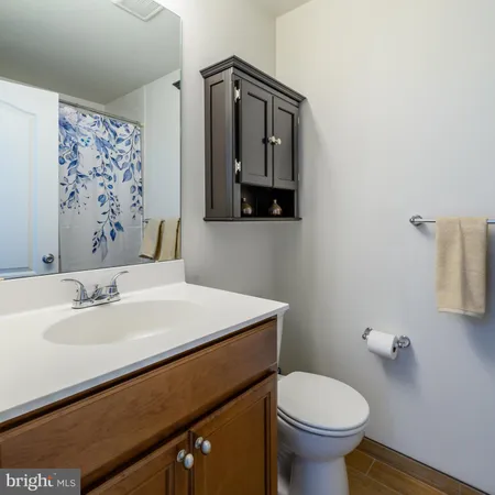 a bathroom with a sink toilet and mirror