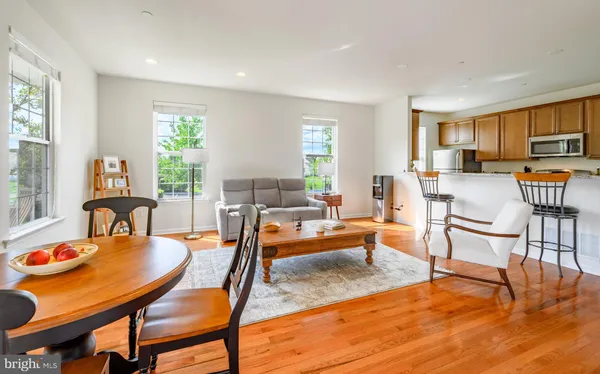 a dining room with furniture and wooden floor