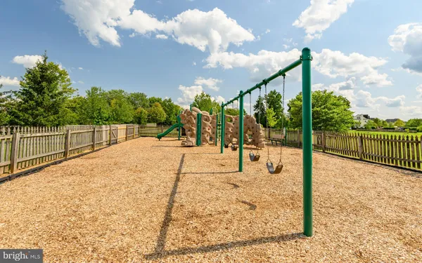 a view of a pathway with a wrought fence