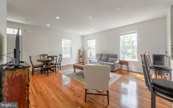 a view of a dining room with furniture window and wooden floor