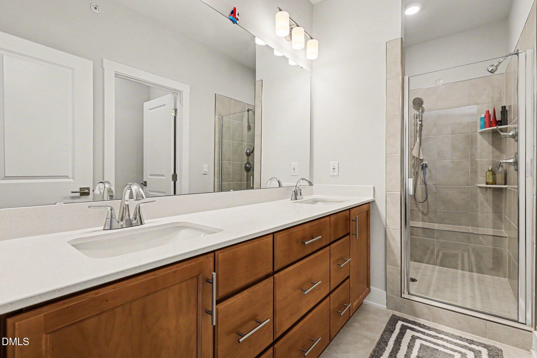 11549 Helmond Way, Unit 115 Raleigh, NC 27617 - Photo 17 of 25 a bathroom with a double vanity sink mirror and double