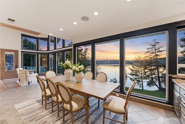 a view of a dining room with furniture large windows and wooden floor