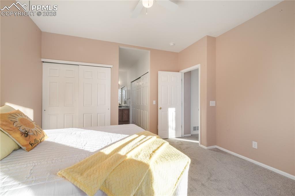 7170 Leeside View Colorado Springs, CO 80922 - Photo 23 of 50 a bedroom with a bed and a mirror