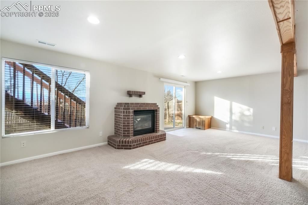 7170 Leeside View Colorado Springs, CO 80922 - Photo 31 of 50 a view of a livingroom with a fireplace