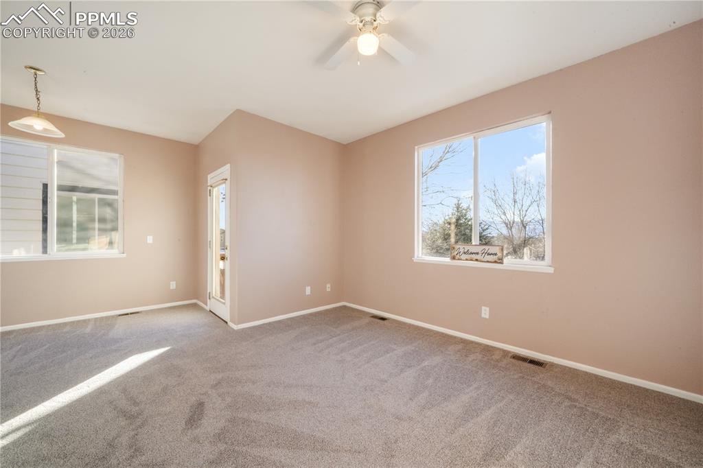 7170 Leeside View Colorado Springs, CO 80922 - Photo 10 of 50 an empty room with windows and fan