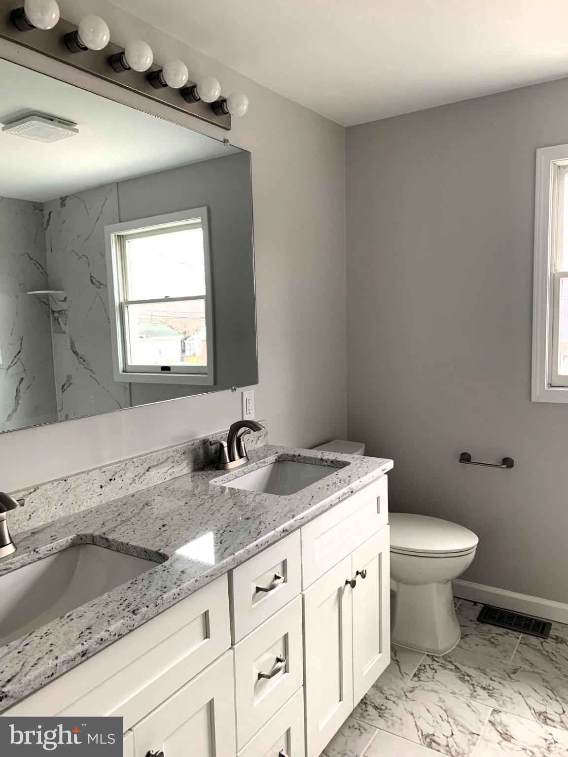 804 South Fairview Street Riverside, NJ 08075 - Photo 13 of 19 a bathroom with a granite countertop toilet sink and mirror