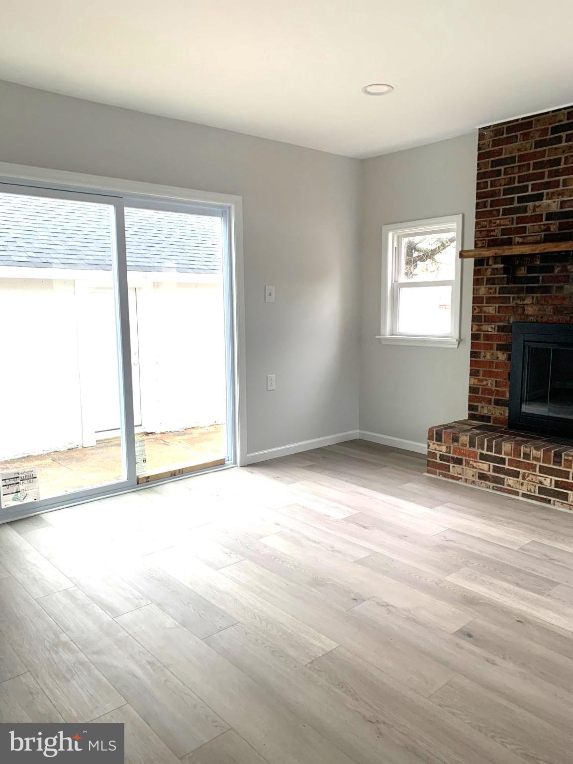 804 South Fairview Street Riverside, NJ 08075 - Photo 5 of 19 a view of a livingroom with wooden floor and a fireplace