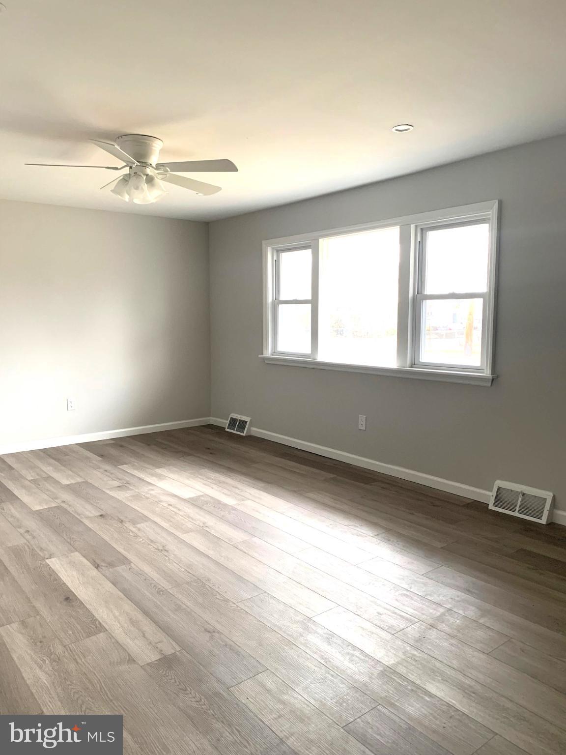 804 South Fairview Street Riverside, NJ 08075 - Photo 7 of 19 an empty room with wooden floor and windows
