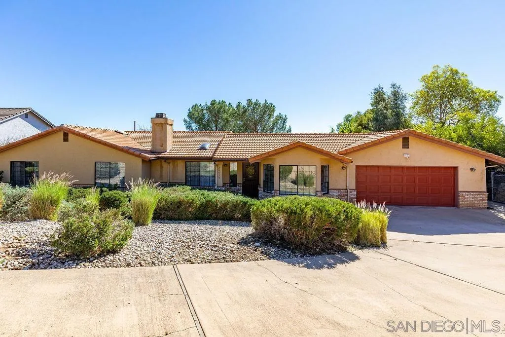 24435 Rutherford Road Ramona, CA 92065 - Photo 4 of 59 a front view of a house with a yard
