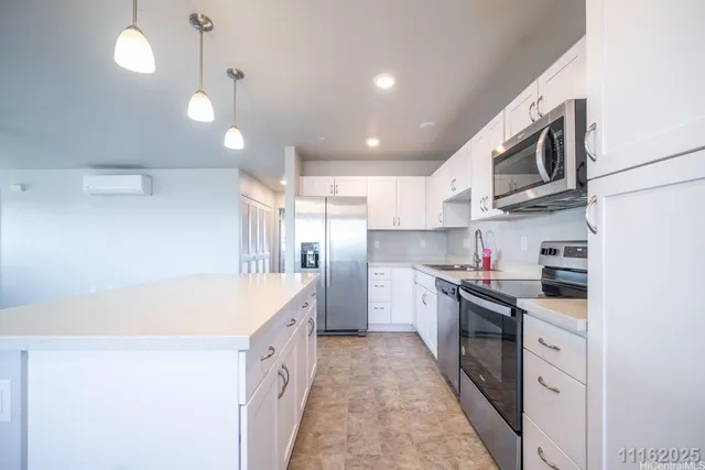 a kitchen with stainless steel appliances granite countertop a sink and a stove