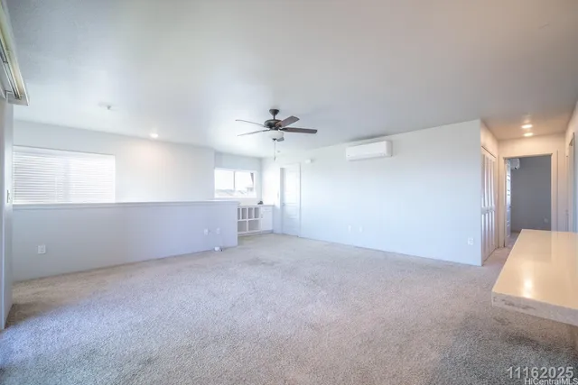 a view of a livingroom and a chandelier fan