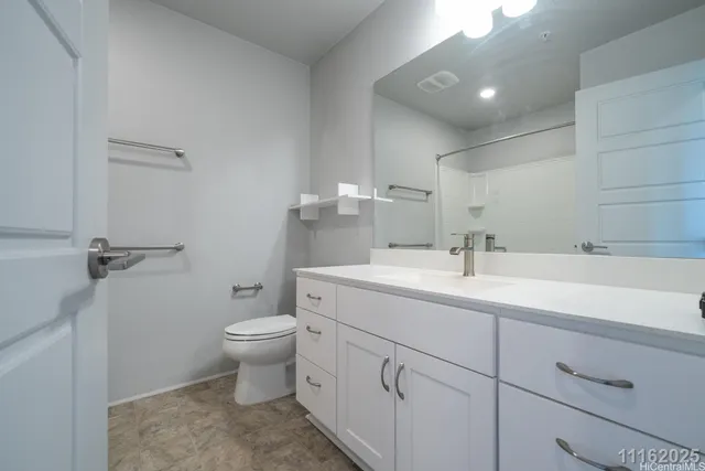 a bathroom with a sink toilet and a mirror