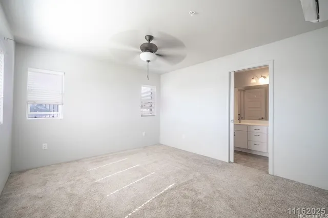 an empty room with a ceiling fan and a window