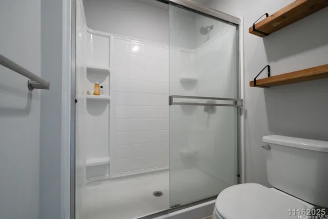 a bathroom with a shower and a toilet