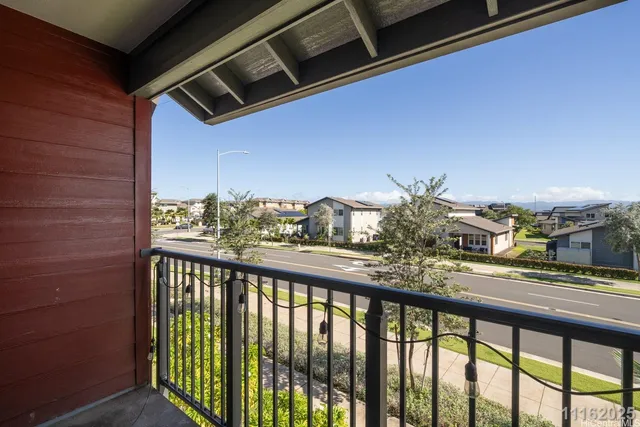 a view of a balcony next to a yard