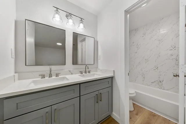 a bathroom with a double vanity sink and a mirror