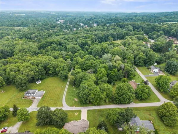 an aerial view of residential houses with outdoor space and swimming pool