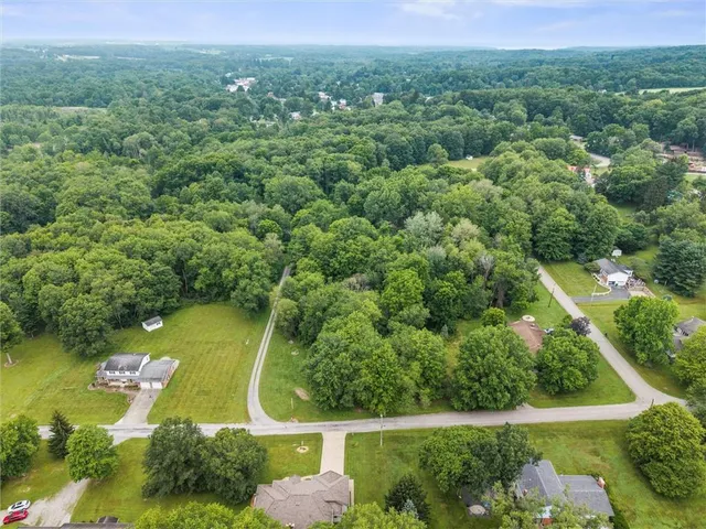 an aerial view of residential houses with outdoor space and swimming pool