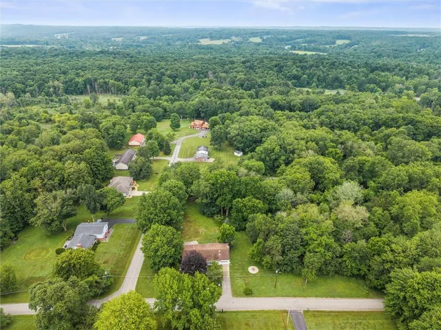 an aerial view of a house with yard