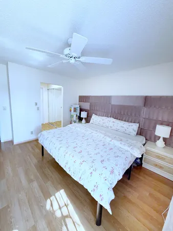 a living room with a bed and chandelier