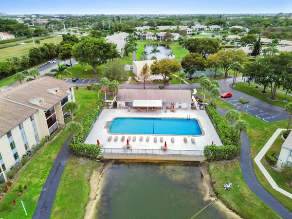 an aerial view of a house with a garden and lake view