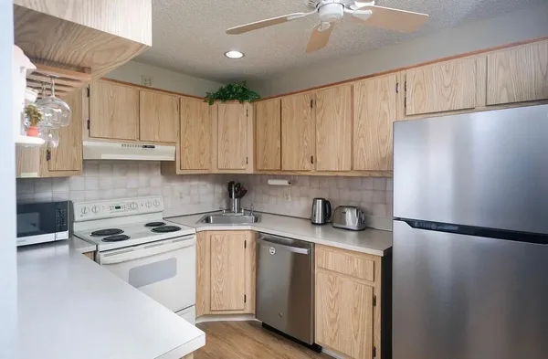 a kitchen with a white cabinets and white appliances