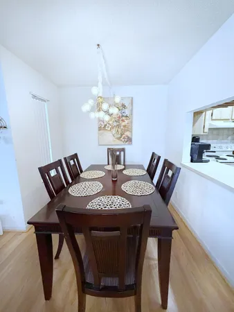 a view of a dining room with furniture and chandelier