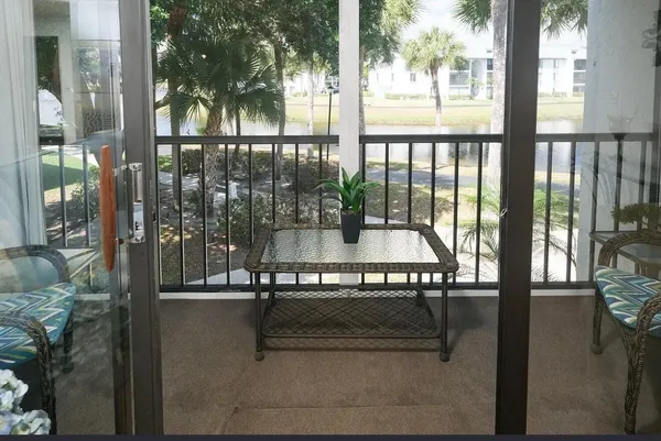 a view of a chairs and table in patio
