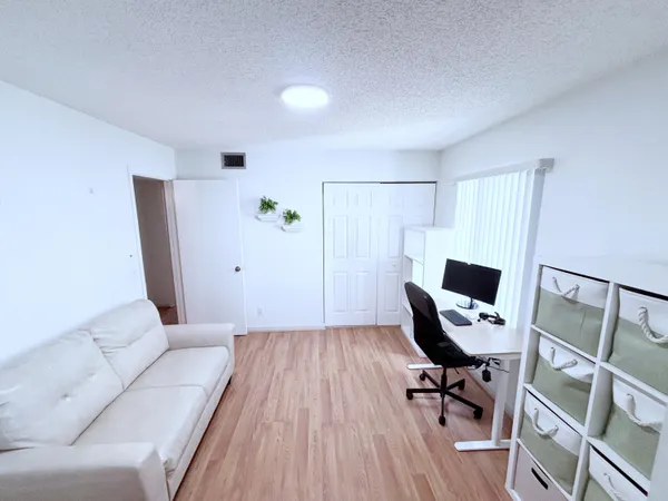 a view of workspace with wooden floor and windows