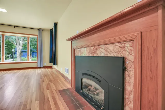 a floor to ceiling window with wooden floor