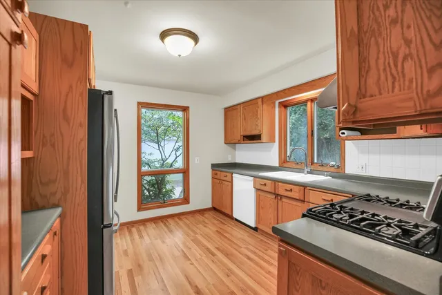 a kitchen with stainless steel appliances granite countertop a stove and a refrigerator