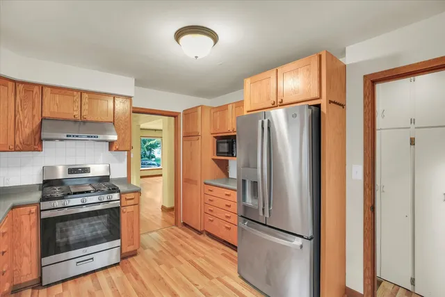 a kitchen with stainless steel appliances a refrigerator stove and microwave