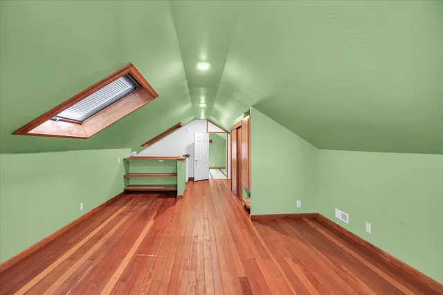 a view of a room with wooden floor