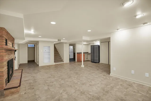 a view of an empty room with a fireplace
