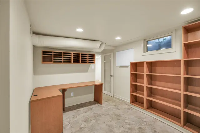 a view of an empty room with a cabinet and a window