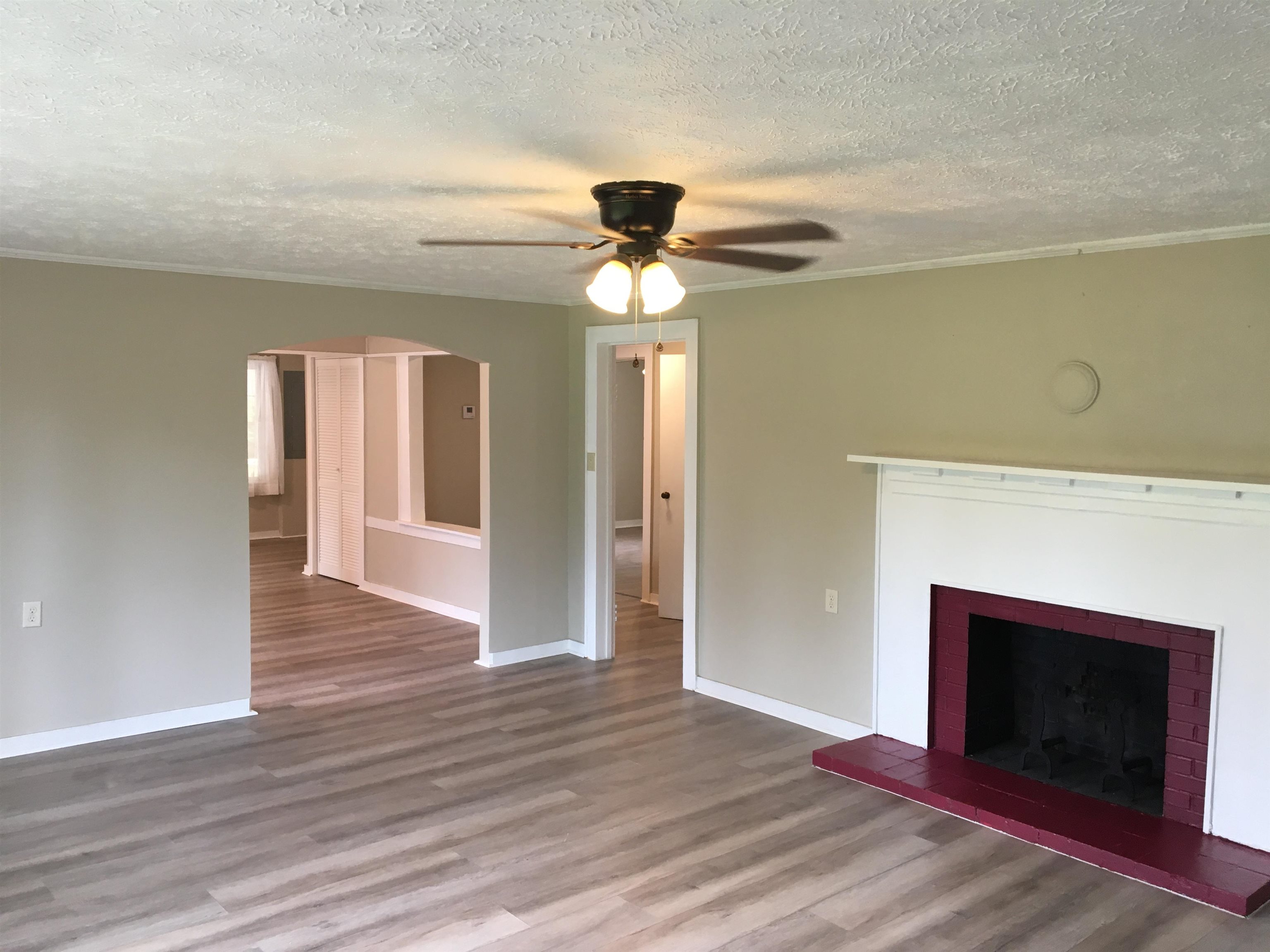 855 Highway 22 Shiloh, TN 38376 - Photo 4 of 24 a view of an empty room with wooden floor fireplace and a window
