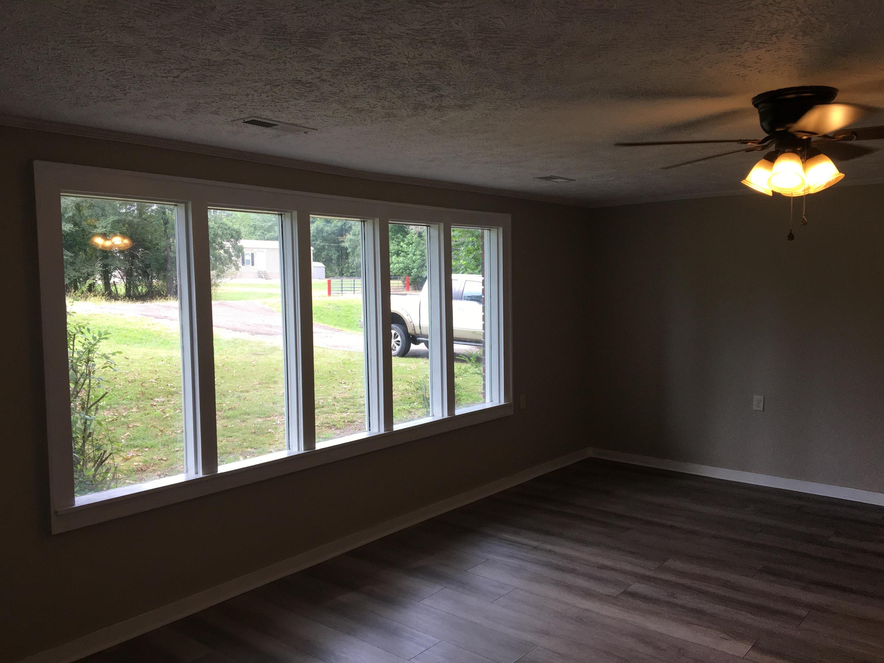855 Highway 22 Shiloh, TN 38376 - Photo 10 of 24 a view of an empty room with wooden floor and a window
