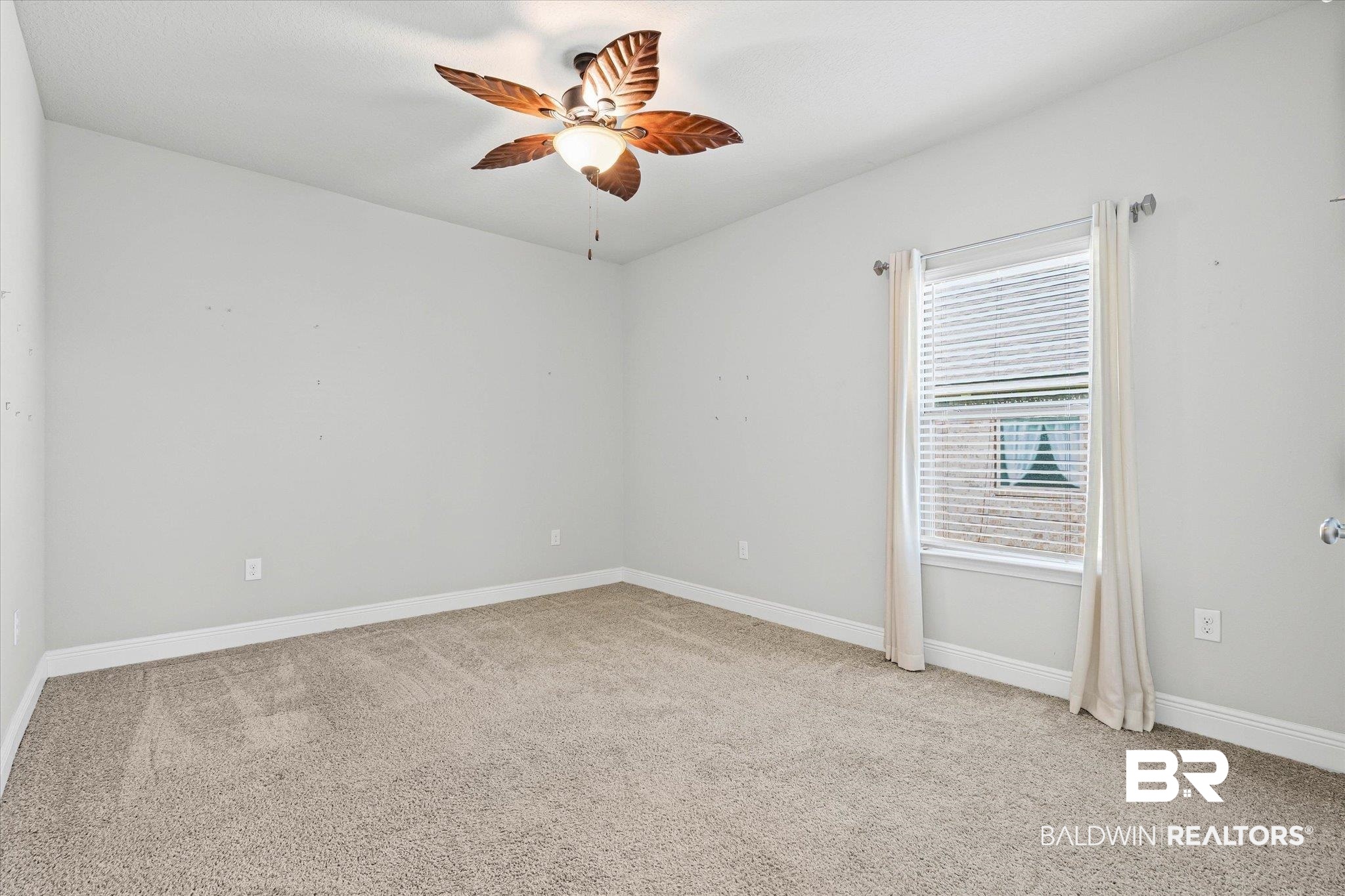 10207 Dunleith Loop Daphne, AL 36526 - Photo 16 of 23 Empty room with light colored carpet and ceiling fan
