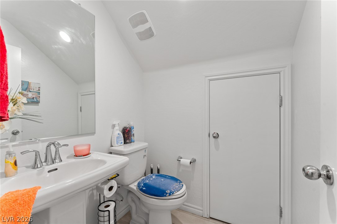 8879 Roadrunner Ravine Street Las Vegas, NV 89166 - Photo 32 of 39 A compact and functional lavatory provides essential amenities within a well-maintained space.
