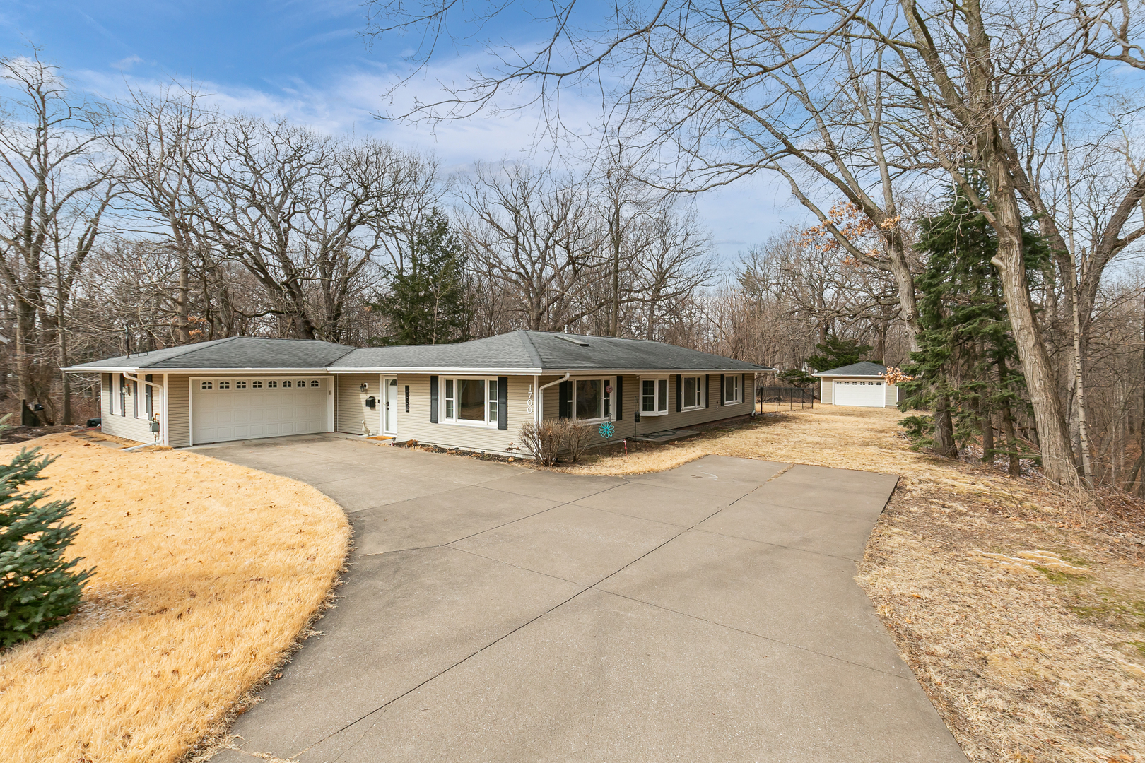 a front view of a house with yard and mountain view