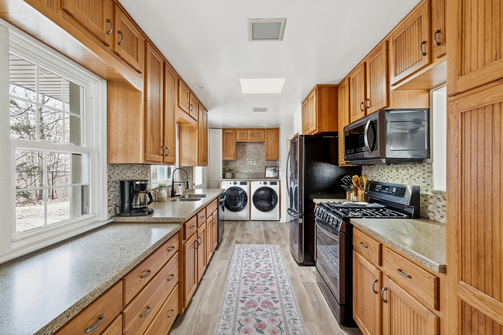 1700 46th Street Moline, IL 61265 - Photo 18 of 45 a kitchen with stainless steel appliances granite countertop a stove a sink and a microwave