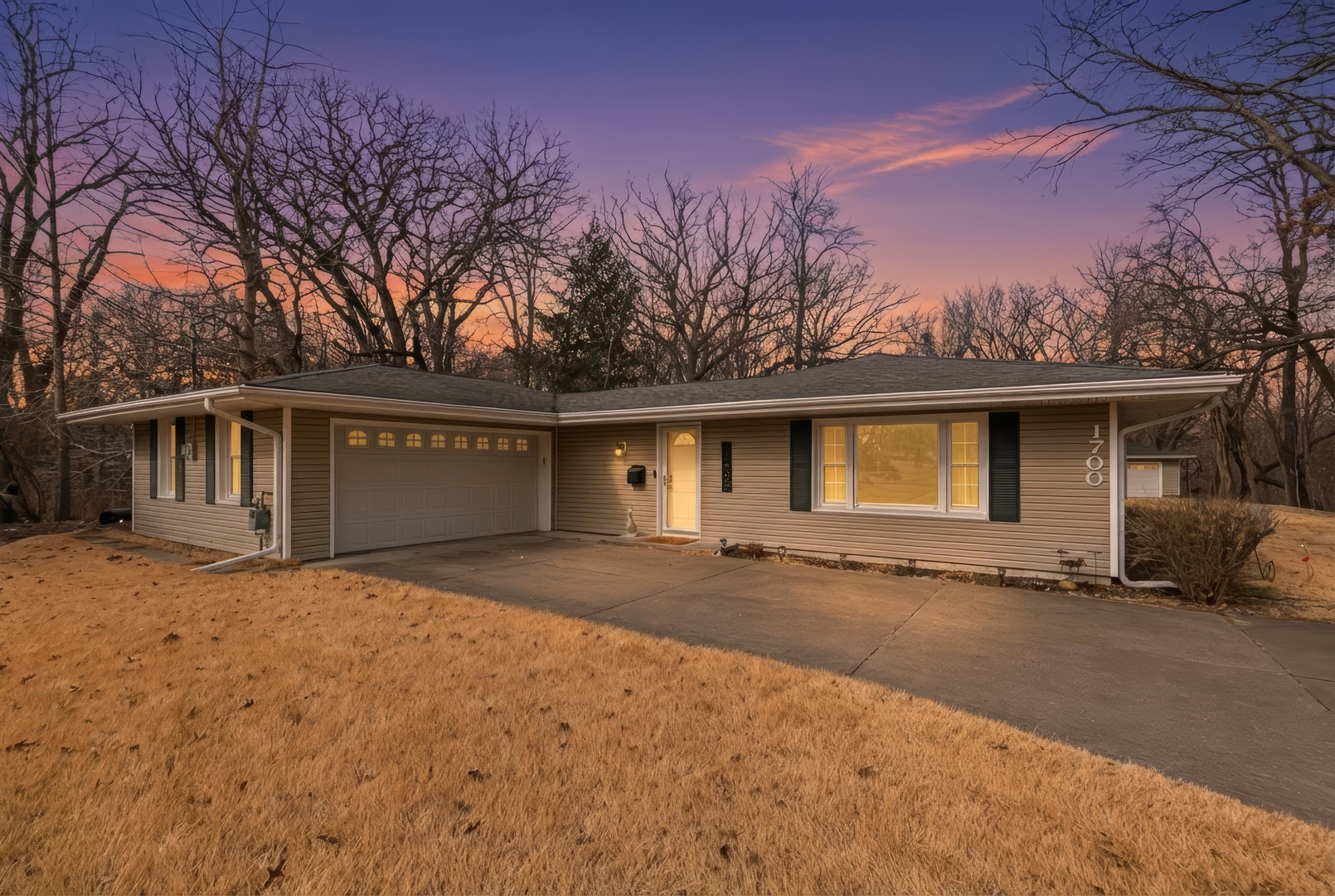 1700 46th Street Moline, IL 61265 - Photo 2 of 45 a front view of a house with a yard and garage