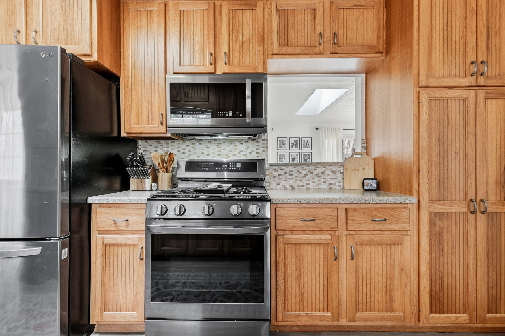 1700 46th Street Moline, IL 61265 - Photo 21 of 45 a kitchen with stainless steel appliances granite countertop a stove microwave and cabinets