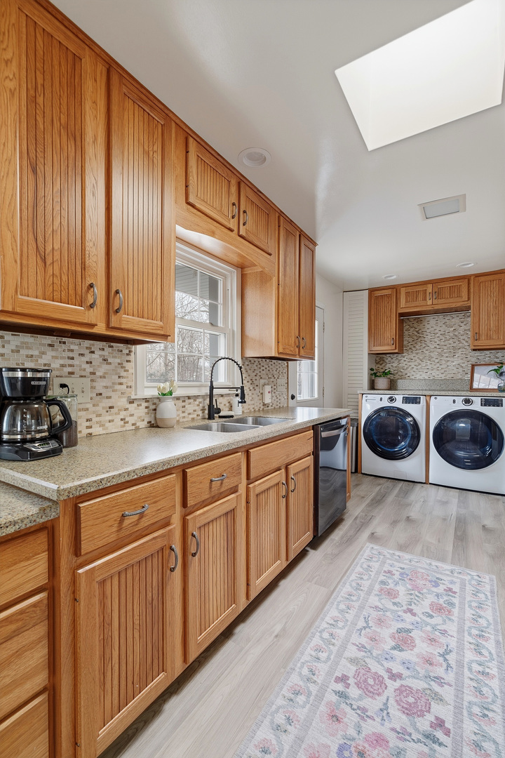 1700 46th Street Moline, IL 61265 - Photo 23 of 45 a kitchen with stainless steel appliances wooden cabinets sink and a stove top oven