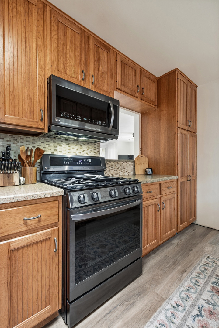 1700 46th Street Moline, IL 61265 - Photo 24 of 45 a kitchen with stainless steel appliances granite countertop a stove microwave and cabinets