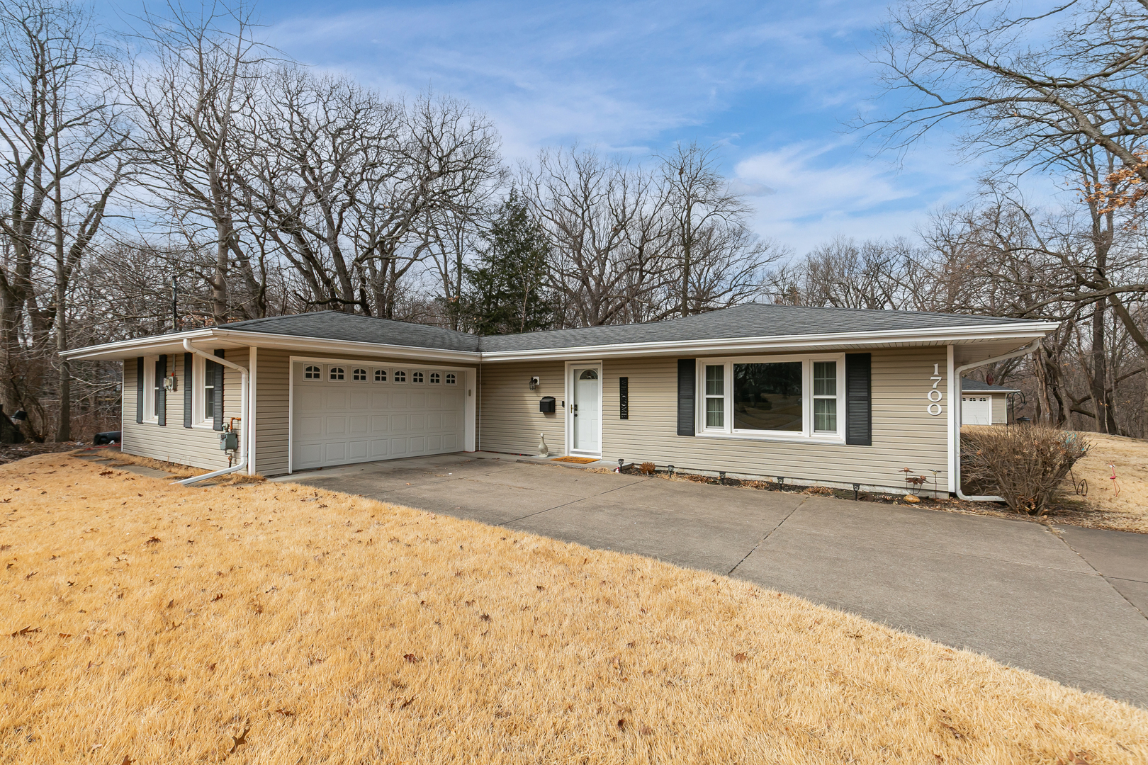1700 46th Street Moline, IL 61265 - Photo 3 of 45 a front view of a house with a yard and garage